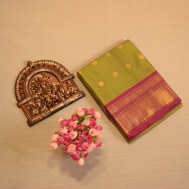 Elegant green Soft Silk Saree with golden motifs and pink border