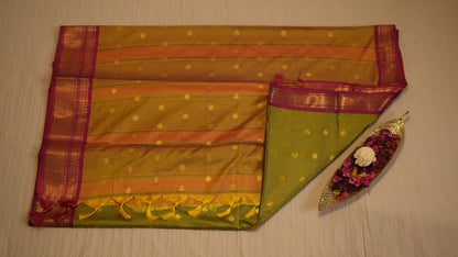 Elegant green Soft Silk Saree with golden motifs and pink border